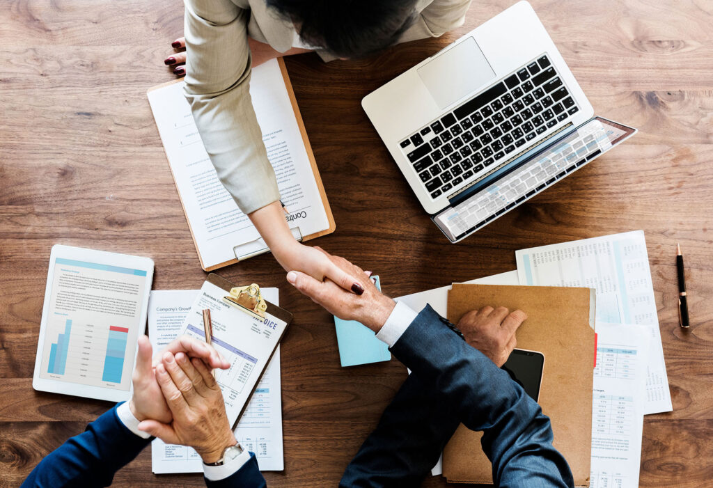 business-people-shaking-hands-together-2